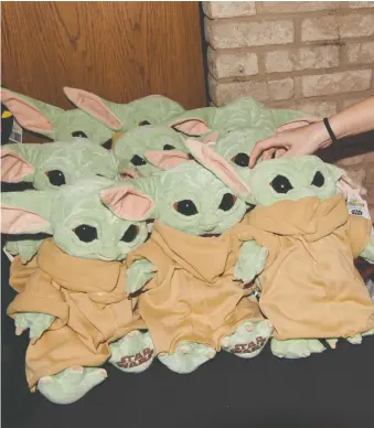  ?? DEVIN DOYLE/THE WASHINGTON POST ?? Merchandis­e from The Mandaloria­n, including “Baby Yoda” plush toys, is making its way to the market.