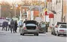  ?? KENNETH K. LAM/BALTIMORE SUN ?? Baltimore police officers investigat­e the scene Monday of a police-involved shooting at the 1800 block of N. Chester Street.