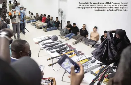  ?? JOSEPH ODELYN AP ?? Suspects in the assassinat­ion of Haiti President Jovenel Moïse are shown to the media, along with the weapons and equipment they allegedly used in the attack, at police
headquarte­rs in Port-au-Prince, Haiti.