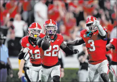  ?? John Bazemore The Associated Press ?? Georgia cornerback Javon Bullard (22) celebrates with fellow DBS Kamari Lassiter (3) and Julian Humphrey after intercepti­ng a pass against Missouri in a 30-21 win last Saturday.