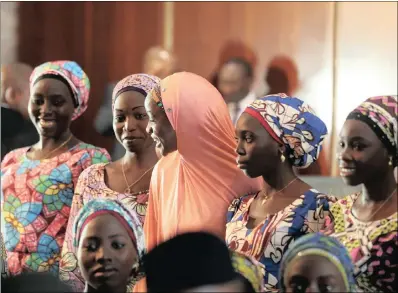  ?? PICTURE: REUTERS ?? Some of the 21 Chibok schoolgirl­s released by Boko Haram look on during their visit to meet President Muhammadu Buhari In Abuja, Nigeria, yesterday.