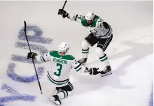  ?? JASON FRANSON/THE CANADIAN PRESS VIA AP ?? Dallas’ John Klingberg (3) and Jamie Benn celebrate a goal against the Calgary Flames during the first round of the playoffs in August. The Stars and Tampa Bay open the Stanley Cup Final Saturday.