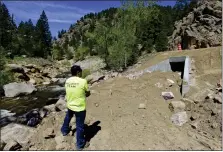  ?? ?? Kiewit Project Manager Ryan Mondragon stands near a new box culvert under Colo. 7 near mile marker 25 in 2022. The road between Lyons and Colo. 72 was closed to through traffic since September 2021, and reopened in time for the 2022 Memorial Day weekend.