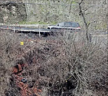  ?? Darrell Sapp/Post-Gazette ?? Trees and debris slide down the hill under Commercial Street, the main connection between Squirrel Hill and Swisshelm Park, toward the Parkway East.