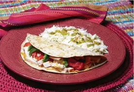  ?? LINDA GASSENHEIM­ER/TRIBUNE NEWS SERVICE ?? Turkey quesadilla and coleslaw with salsa verde.