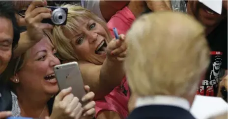  ?? JOHN LOCHER/THE ASSOCIATED PRESS ?? Republican voters — such as these at a Las Vegas campaign rally Monday — are likely to grant Donald Trump the delegates needed for his nomination.