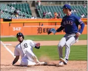  ?? ?? Detroit Tigers’ Matt Vierling scores from third on a wild pass by Texas Rangers pitcher Jacob Latz, right, during the eighth inning of a baseball game, Tuesday, in Detroit.