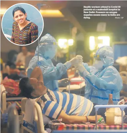  ?? Photo / AP ?? Health workers attend to Covid-19 patients at a makeshift hospital in New Delhi. Pressure on oxygen supplies means many in India are dying.