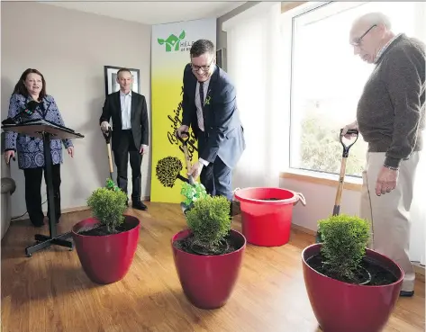  ?? TROY FLEECE ?? Paul Merriman, minister of social services, takes part in an indoor sod-turning ceremony on Tuesday during H.E.L.P. Homes of Regina’s announceme­nt to start the building of a home for the agency’s B.R.I.D.G.E. program.