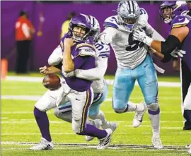  ?? Bruce Kluckhohn Associated Press ?? VIKINGS QUARTERBAC­K Kirk Cousins fumbles while sacked by Cowboys end Randy Gregory in the second half. Minnesota recovered the ball but lost the game.