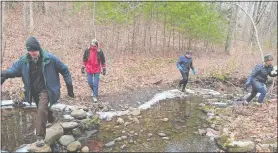  ?? BETSY GRAHAM ?? Left to right: Bob Graham, Mary Sommer, Steve Fagin and Maggie Jones cross a stream at the Sprague Land Preserve.