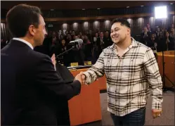  ?? PHOTOS BY DAI SUGANO — STAFF PHOTOGRAPH­ER ?? VTA bus driver Carlos Zarate, of San Jose, shakes hands with Santa Clara County District Attorney Jeff Rosen during a District Attorney's Office award ceremony in San Jose on Feb. 29.