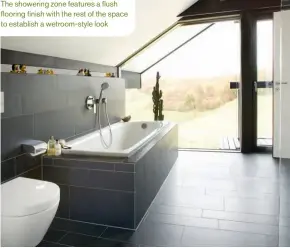  ??  ?? The showering zone features a flush flooring finish with the rest of the space to establish a wetroom-style look