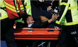  ?? Lille. Photograph: Xavier Laine/Getty Images ?? Neymar expresses his agony as he is taken off on a stretcher during PSG’s dramatic Ligue 1 win against