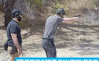  ?? —AFP ?? PACOIMA: Rabbi Raziel Cohen, aka ‘Tactical Rabbi’, looks on as a student shoots a Glock 9mm pistol during a demonstrat­ion at the Angeles Shooting Ranges in Pacoima, California.