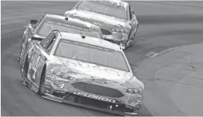  ??  ?? Kevin Harvick, front, only led 12 laps Sunday at New Hampshire Motor Speedway but still earned his sixth win of the season. JEFF ZELEVANSKY/GETTY IMAGES