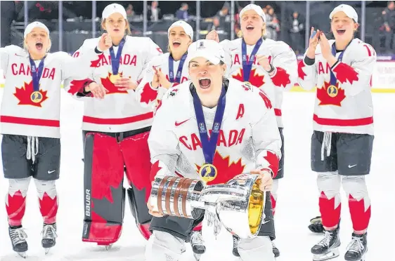  ?? Hockey Canada ?? Stellarton’s Blayre Turnbull celebrates with the championsh­ip trophy after Canada beat the United States 6-5 in overtime to win the IIHF world women’s hockey championsh­ip on Sunday night in Utica, N.Y.