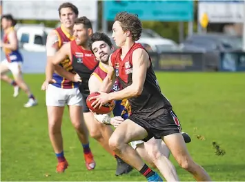  ?? ?? Luke Garner eludes his Moe pursuer as he looks for a Warragul teammate to lead in the reserves match.