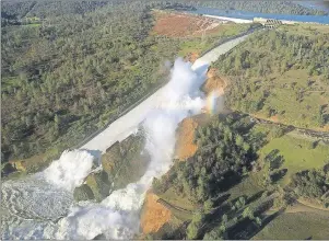  ?? CALIFORNIA DEPARTMENT OF WATER RESOURCES VIA AP ?? This Saturday aerial photo shows the damaged spillway with eroded hillside in Oroville, Calif. Water will continue to flow over an emergency spillway at the U.S.’s tallest dam for another day or so, officials said Sunday.