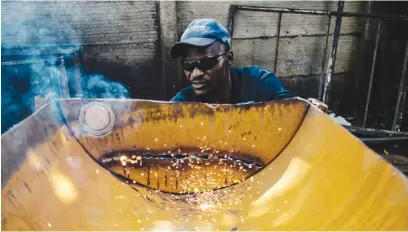  ?? Pictures: AFP ?? SPARKS. Welder Trust Pirai makes a braai stand from scrap metal using his welding machine, delivered to him from South Africa, at his rented lodgings in Kuwadzana township in Harare this week.