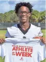  ?? ?? Royal Palm Beach’s Garvan Dorival poses with his Athlete of the Week shirt on Nov. 10.