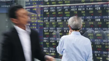  ?? KAZUHIRO NOGI/AFP/GETTY IMAGES FILES ?? Change has been slow in Japan, but there are signs its fortunes may be improving considerin­g what appears to be a swift and sustained rally of the Nikkei 225 index over the past month or so, says Joe Chidley. The Nikkei 225 closed Thursday at nearly...