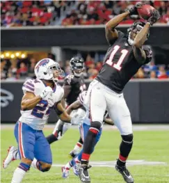  ?? THE ASSOCIATED PRESS ?? Atlanta wide receiver Julio Jones makes a catch while covered by Buffalo’s Leonard Johnson during the Falcons’ 23-17 loss to the Bills on Oct. 1 at Mercedes-Benz Stadium. The Falcons are working to get Jones more involved in the offense.