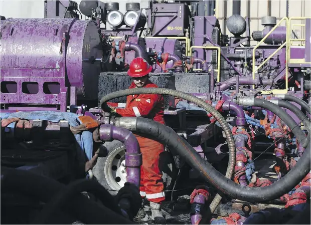  ?? BRENNAN LINSLEY / THE ASSOCIATED PRESS ?? A worker adjusts hoses at a hydraulic fracturing operation near Mead, Colo. U. S. gas exports are set to soar by 2020 thanks to its LNG sector.