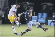  ?? JOHN RAOUX — THE ASSOCIATED PRESS ?? Earthquake­s defender Oswaldo Alanis, left, takes a shot as Whitecaps midfielder Russell Teibert defends during the first half of their match on Wednesday in Kissimmee, Fla.