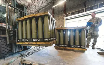  ?? AP ?? US Air Force Staff Sgt. Cody Brown with the 436th Aerial Port Squadron, checks pallets of 155mm shells ultimately bound for Ukraine at Dover Air Force Base, Del.