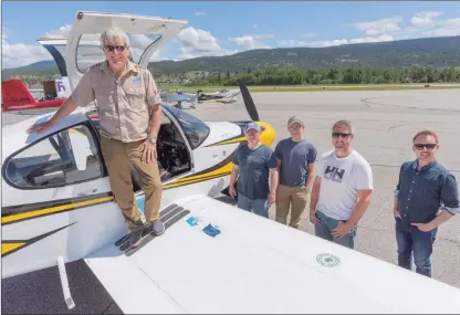  ?? GARY NYLANDER PHOTOS/Special to The Daily Courier ?? Dave McElroy stands on a wing of his plane at Kelowna Flying Club on Monday while, from left, Dave Lamb, Alexander Lamb, Kyle Crawford and Shawn Talbot look on. Below, the planes fly in formation.