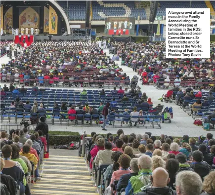  ??  ?? A large crowd attend mass in the Family Arena during the World Meeting of families in the RDS; below, closed order Carmelite nuns Sr Bernadette and Sr Teresa at the World Meeting of Families. Photos: Tony Gavin