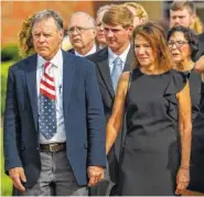  ?? THE ASSOCIATED PRESS ?? Fred and Cindy Warmbier watch as their son Otto’s casket is placed in a hearse after his funeral,Thursday in Wyoming, Ohio.