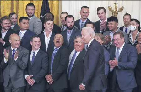  ?? JULIO CORTEZ — THE ASSOCIATED PRESS ?? Los Angeles Dodgers manager Dave Roberts, third from bottom left, reacts as President Joe Biden arrives at an event to honor the 2020World Series champion Dodgers baseball team at the White House on Friday in Washington.