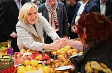  ?? Joan Mateu Parra / Associated Press ?? French far-right leader Marine Le Pen tours a food market in Narbonne, southern France, Friday.