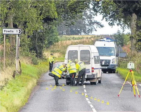  ??  ?? Police at the scene of the crash on the A923 between Dundee and Coupar Angus.