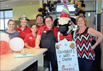  ?? / Kevin Myrick ?? Staff at Chick-fil-A of Rockmart gathered on Friday, Sept. 14 during the lunch hour for a brief moment to celebrate the restaurant’s first birthday. This week Chick-fil-A has several events going on to continue the inaugural anniversar­y of their opening.