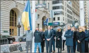  ?? ?? The Ukrainian flag is pictured before being raised near the iconic Charging Bull in Bowling Green Park on Friday.