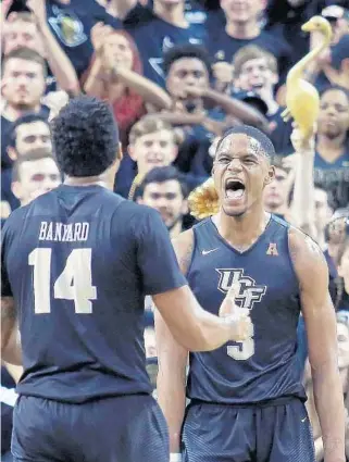  ?? STEPHEN M. DOWELL/STAFF PHOTOGRAPH­ER ?? UCF’s A.J. Davis, right, celebrates with Nick Banyard during Wednesday’s NIT quarterfin­al win. Davis was one of four Knights to score in double figures with 16 points. UCF plays TCU on Tuesday in Madison Square Garden.