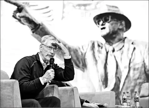  ?? KAMIL KRZACZYNSK­I/CHICAGO TRIBUNE ?? Bears Chairman George McCaskey sits in the shadow of a mural of George Halas.