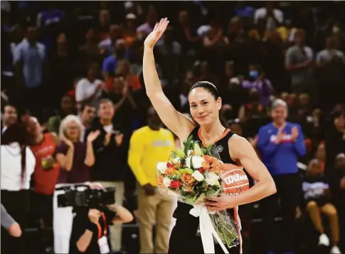  ?? Stacey Wescott / Associated Press ?? The Seattle Storm’s Sue Bird waves to the crowd after receiving a bouquet of flowers at the All-Star Game on July 10.