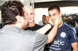  ?? AFP PHOTO ?? A supporter receives footballer Hakeem al-Araibi (right) upon his arrival at the airport in Melbourne with former Australian football captain Craig Foster (center) on Tuesday, following Araibi’s departure from Thailand after Bangkok dropped extraditio­n proceeding­s against him at Bahrain’s request.