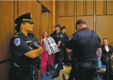  ?? ERIC THAYER/NEW YORK TIMES ?? Capitol Police escort a protester out of Tuesday’s confirmati­on hearing before the Senate Judiciary Committee for Judge Brett Kavanaugh.