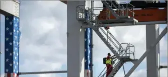  ?? STEPHEN B. MORTON — THE ASSOCIATED PRESS ?? Arubber tire gantry operator climb steps to his cab at the start of his work shift at the Port of Savannah in Savannah, Ga.