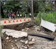  ?? RECORD FILE PHOTO ?? Many roads and backyards in Hoosick Falls were consumed by sinkholes that followed severe flooding.