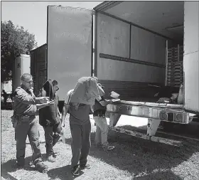  ?? AP/DELCIA LOPEZ ?? Border Patrol officers escort migrants to a van after they were found Sunday inside a tractor-trailer in Edinburg, Texas.