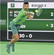  ?? JAYNE KAMIN-ONCEA/USA TODAY SPORTS ?? Novak Djokovic hits a shot against Luca Nardi during a BNP Paribas Open match March 11 in Indian Wells, Calif.