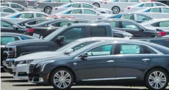  ??  ?? Vehicles are seen in a parking lot at a General Motors assembly plant in Oshawa, Ont. If Canada’s auto sector becomes a Trump target, many fear Canadian countermea­sures would have a far greater impact on jobs and the economy in this country than the...