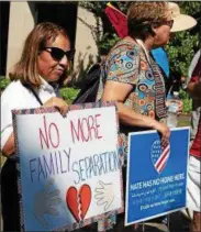  ?? JAMES SALVAS – DIGITAL FIRST MEDIA ?? Protesters display signs during rally Saturday on the steps of the Chester County Courthouse to show support for immigrant families.