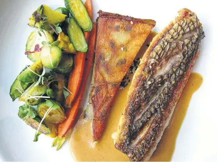  ?? Photos by Mike Sutter / Staff ?? Pan-seared red snapper with ginger-soy sauce, vegetables and potato galette from Spoon Eatery